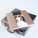 Fotolibro de boda premium con portada de ecopiel y foto insertada de los novios, bolsa de presentación